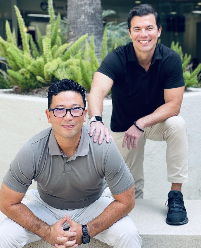 Two men posing outdoors